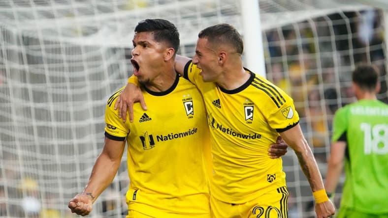 Aug 20, 2023; Columbus, Ohio, USA; Columbus Crew forward Cucho Hernandez (9) celebrates scoring a penalty kick goal with midfielder Alexandru Matan (20) behind FC Cincinnati goalkeeper Roman Celentano (18) during the first half of the MLS soccer match at Lower.com Field.