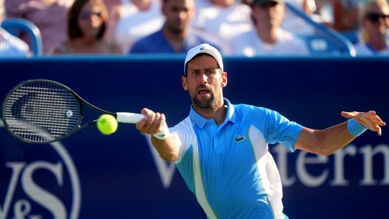 Novak Djokovic, of Serbia returns a shot to Carlos Alcaraz, of Spain, during the men   s singles final of the Western & Southern Open tennis tournament, Sunday, Aug. 20, 2023, at the Lindner Family Tennis Center in Mason, Ohio.