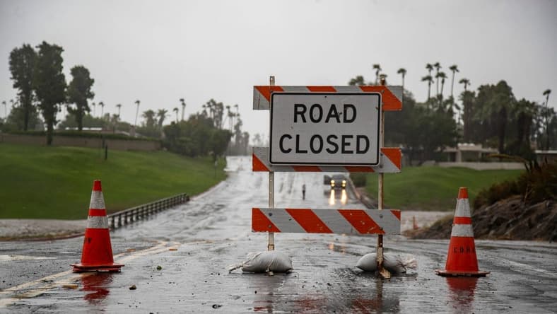 Country Club Drive is seen closed at the storm channel in Rancho Mirage, Calif., Sunday, Aug. 20, 2023.