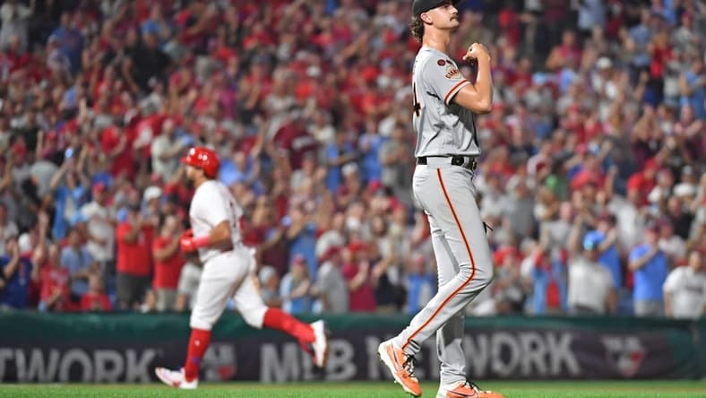 Aug 21, 2023; Philadelphia, Pennsylvania, USA; San Francisco Giants relief pitcher Sean Hjelle (64) reacts after allowing two-run home run to Philadelphia Phillies left fielder Kyle Schwarber (12) during the seventh inning at Citizens Bank Park. Mandatory Credit: Eric Hartline-USA TODAY Sports