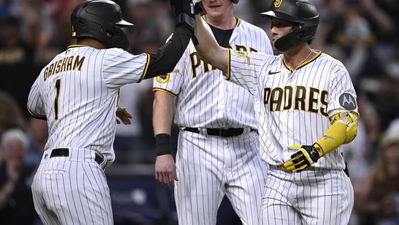Aug 21, 2023; San Diego, California, USA; San Diego Padres second baseman Ha-seong Kim (7) is congratulated by center fielder Trent Grisham (1) after hitting a grand slam home run against the Miami Marlins during the second inning at Petco Park. Mandatory Credit: Orlando Ramirez-USA TODAY Sports