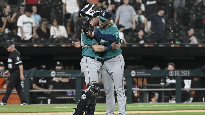 Aug 21, 2023; Chicago, Illinois, USA;  Seattle Mariners catcher Brian O'Keefe (64) and Seattle Mariners relief pitcher Darren McCaughan (26) after the game against the Chicago White Sox at Guaranteed Rate Field. Mandatory Credit: Matt Marton-USA TODAY Sports