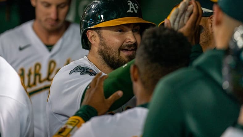 Aug 21, 2023; Oakland, California, USA; Oakland Athletics catcher Shea Langeliers (23) celebrates with teammates in the dugout after hitting a solo homer against the Kansas City Royals during the sixth inning at Oakland-Alameda County Coliseum. Mandatory Credit: Neville E. Guard-USA TODAY Sports