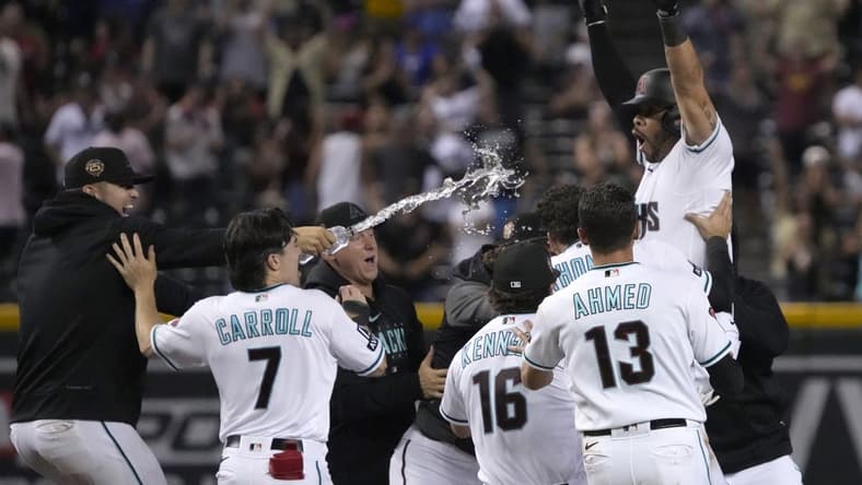 Aug 21, 2023; Phoenix, Arizona, USA; Arizona Diamondbacks left fielder Tommy Pham (28) celebrates with temamates after hitting a two run walk off double during the eleventh inning against the Texas Rangers at Chase Field. Mandatory Credit: Rick Scuteri-USA TODAY Sports