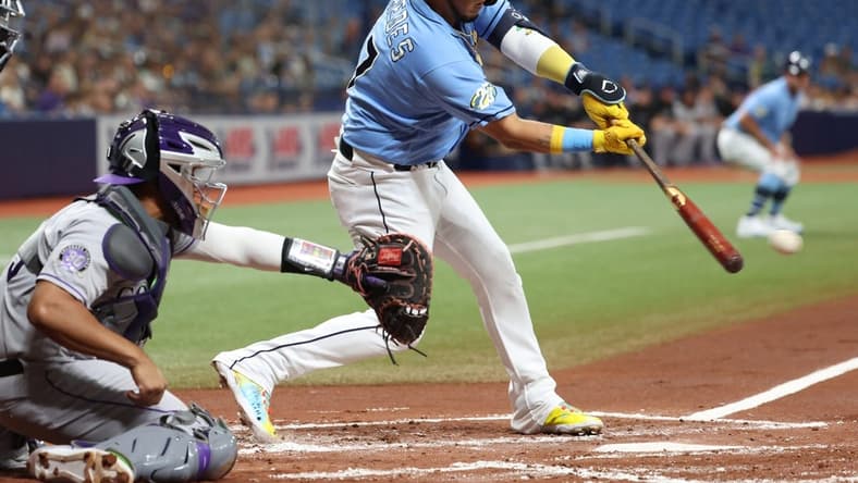 Aug 22, 2023; St. Petersburg, Florida, USA; Tampa Bay Rays third baseman Isaac Paredes (17) hits a sacrifice RBI against the Colorado Rockies during the first inning at Tropicana Field. Mandatory Credit: Kim Klement Neitzel-USA TODAY Sports