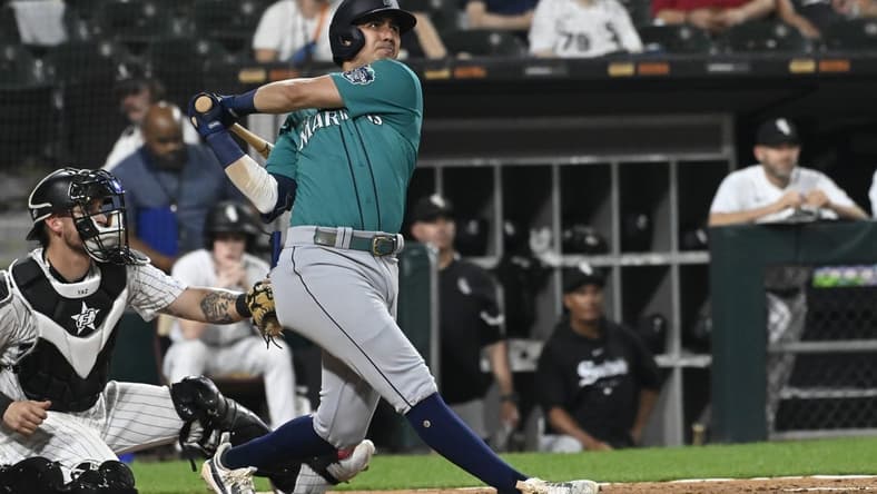 Aug 22, 2023; Chicago, Illinois, USA; Seattle Mariners third baseman Josh Rojas (4) hits a two run home run against the Chicago White Sox during the fourth inning at Guaranteed Rate Field. Mandatory Credit: Matt Marton-USA TODAY Sports