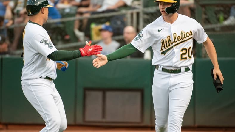 Aug 22, 2023; Oakland, California, USA; Oakland Athletics second baseman Zack Gelof (20) celebrates with shortstop Aledmys Diaz (12) after scoring during the first inning against the Kansas City Royals at Oakland-Alameda County Coliseum. Mandatory Credit: Ed Szczepanski-USA TODAY Sports