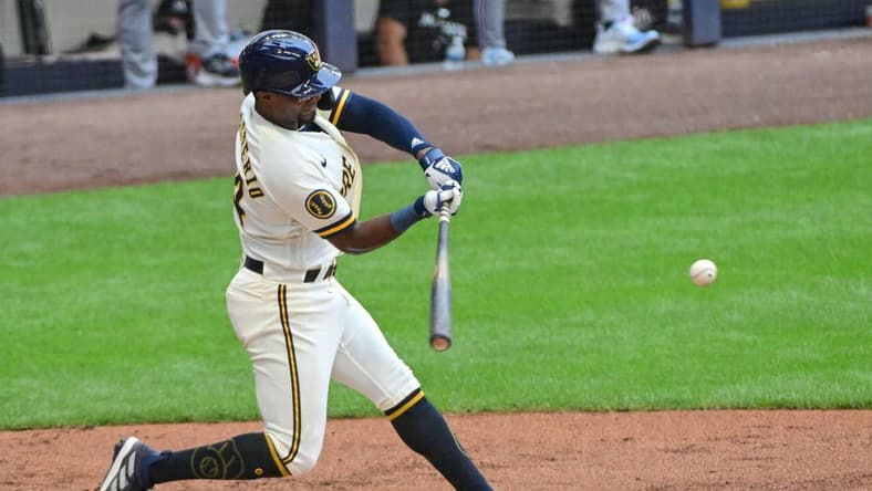 Aug 23, 2023; Milwaukee, Wisconsin, USA; Milwaukee Brewers third baseman Andruw Monasterio (14) drives in two runs with a base hit against the Minnesota Twins in the first inning at American Family Field. Mandatory Credit: Benny Sieu-USA TODAY Sports
