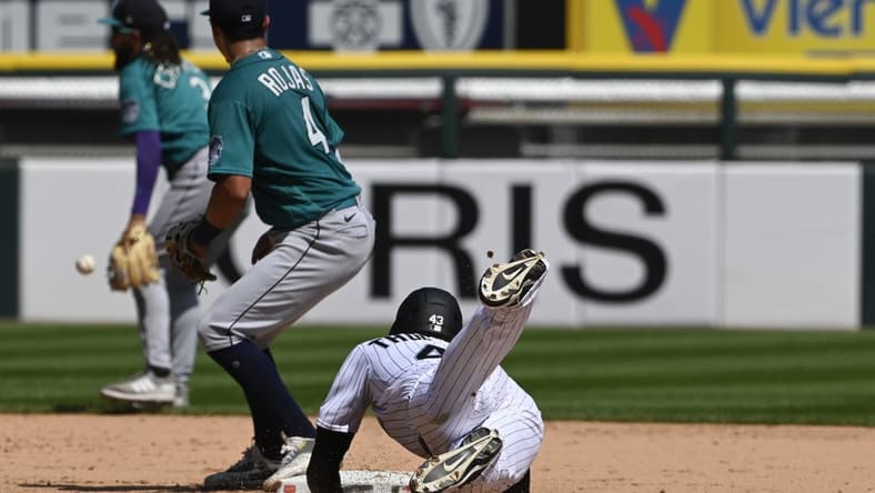 Aug 23, 2023; Chicago, Illinois, USA;  Chicago White Sox center fielder Trayce Thompson (43) slides into second base after hitting a double as Seattle Mariners  second baseman Josh Rojas (4) catches the ball during the fourth inning at Guaranteed Rate Field. Mandatory Credit: Matt Marton-USA TODAY Sports