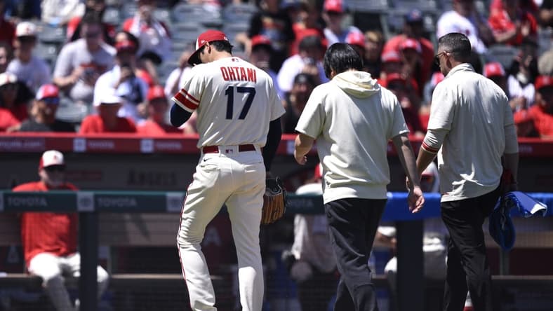 Aug 23, 2023; Anaheim, California, USA; Los Angeles Angels starting pitcher Shohei Ohtani (17) leaves the field during the second inning against the Cincinnati Reds at Angel Stadium. Mandatory Credit: Orlando Ramirez-USA TODAY Sports