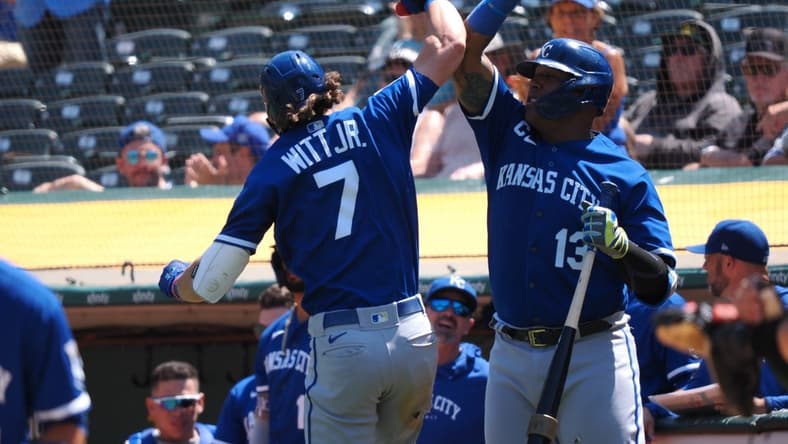 Aug 23, 2023; Oakland, California, USA; Kansas City Royals shortstop Bobby Witt Jr. (7) celebrates with first baseman Salvador Perez (13) after hitting a solo home run against the Oakland Athletics during the fifth inning at Oakland-Alameda County Coliseum. Mandatory Credit: Kelley L Cox-USA TODAY Sports