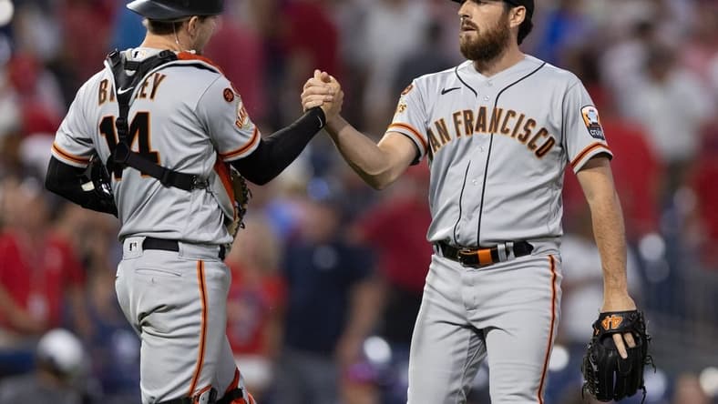 Aug 23, 2023; Philadelphia, Pennsylvania, USA; San Francisco Giants pitcher Ryan Walker (R) and catcher Patrick Bailey (14) shake hands after a victory against the Philadelphia Phillies at Citizens Bank Park. Mandatory Credit: Bill Streicher-USA TODAY Sports