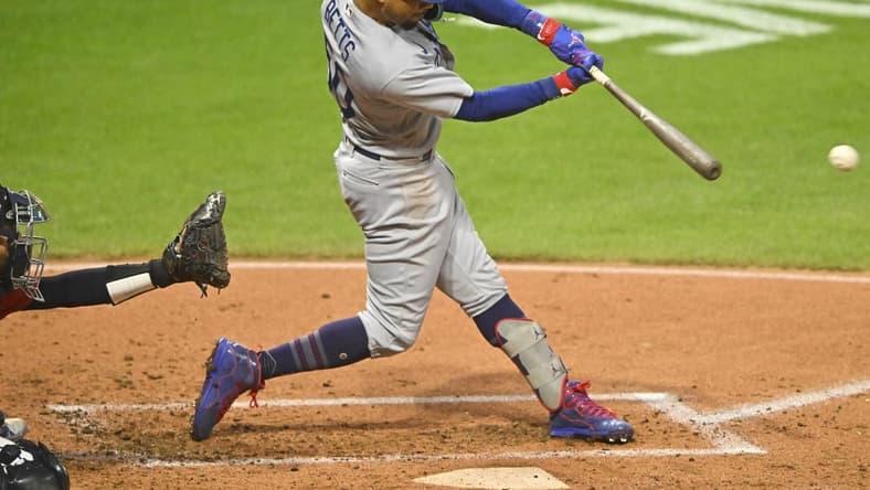 Aug 23, 2023; Cleveland, Ohio, USA; Los Angeles Dodgers right fielder Mookie Betts (50) singles in the second inning against the Cleveland Guardians at Progressive Field. Mandatory Credit: David Richard-USA TODAY Sports