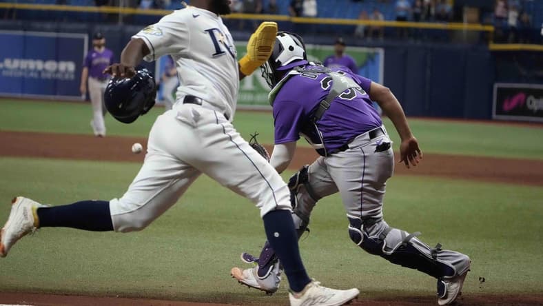 Aug 23, 2023; St. Petersburg, Florida, USA; Tampa Bay Rays shortstop Osleivis Basabe (37) scores the winning run off a hit by second baseman Brandon Lowe (8) as Colorado Rockies catcher Elias Diaz (35) tries to make the tag during the tenth inning at Tropicana Field. Mandatory Credit: Dave Nelson-USA TODAY Sports