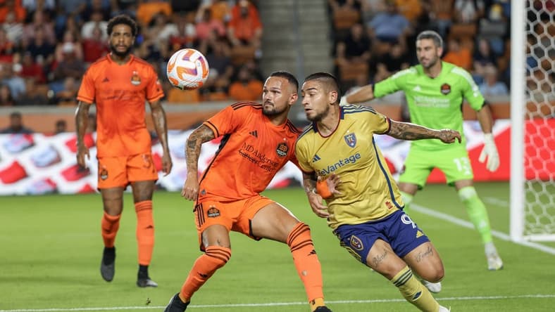 Aug 23, 2023; Houston, TX, USA;Houston Dynamo midfielder Artur (6) and Real Salt Lake forward Christian Chico Arango (9) tie each other up in the first half at Shell Energy Stadium. Mandatory Credit: Thomas Shea-USA TODAY Sports