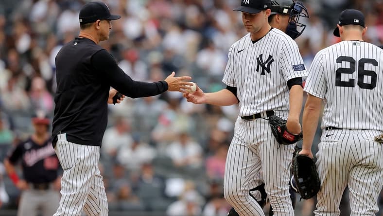 Aug 24, 2023; Bronx, New York, USA; New York Yankees manager Aaron Boone (17) takes the ball from starting pitcher Michael King (34) during the third inning against the Washington Nationals at Yankee Stadium. Mandatory Credit: Brad Penner-USA TODAY Sports