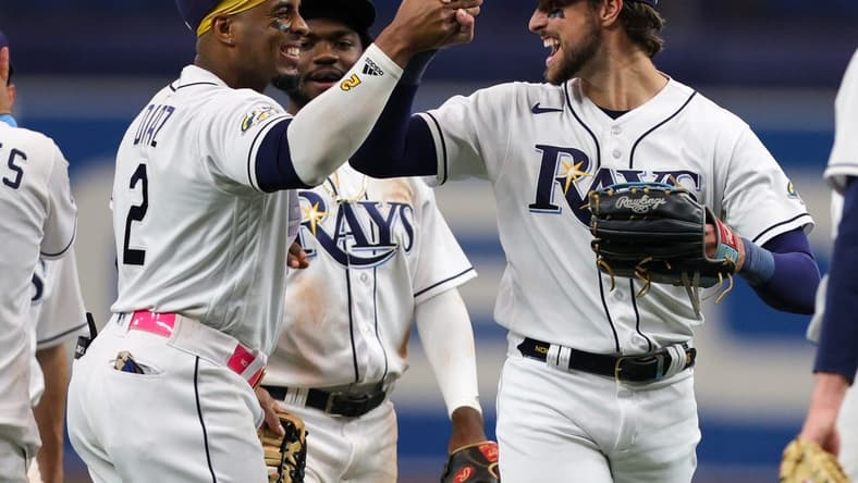 Aug 24, 2023; St. Petersburg, Florida, USA;  Tampa Bay Rays right fielder Josh Lowe (15) and first baseman Yandy Diaz (2) celebrate after beating the Colorado Rockies at Tropicana Field. Mandatory Credit: Nathan Ray Seebeck-USA TODAY Sports