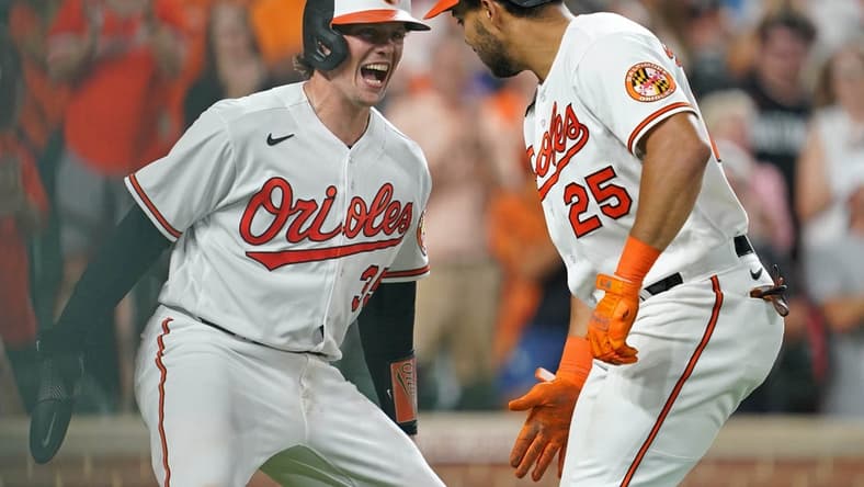 Aug 24, 2023; Baltimore, Maryland, USA; Baltimore Orioles outfielder Anthony Santander (25) greeted by catcher Adley Rutschman (35) following his two run home run in the fourth inning against the Toronto Blue Jays at Oriole Park at Camden Yards. Mandatory Credit: Mitch Stringer-USA TODAY Sports