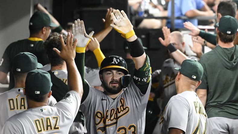Aug 24, 2023; Chicago, Illinois, USA;  Oakland Athletics catcher Shea Langeliers (23) celebrates in the dugout after he hits a three run homerun against the Chicago White Sox during the fourth inning at Guaranteed Rate Field. Mandatory Credit: Matt Marton-USA TODAY Sports