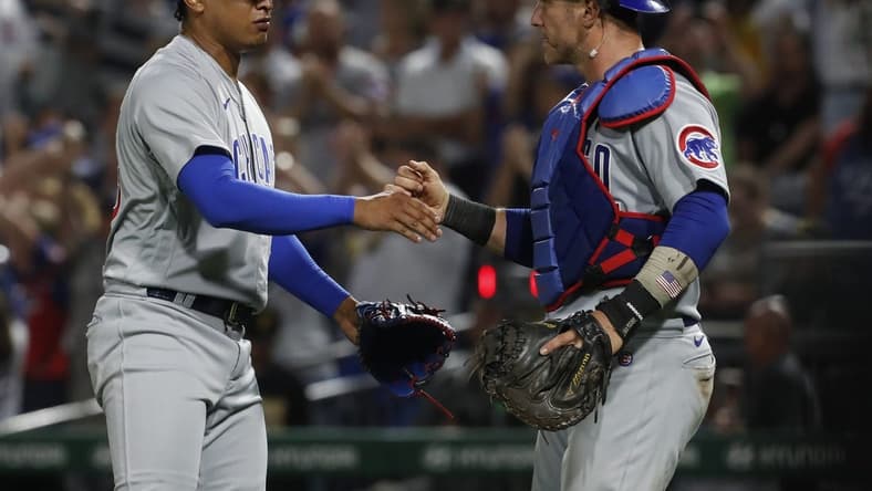 Aug 24, 2023; Pittsburgh, Pennsylvania, USA;  Chicago Cubs relief pitcher Adbert Alzolay (73) and catcher Yan Gomes (15) shake hands after defeating the Pittsburgh Pirates at PNC Park. Mandatory Credit: Charles LeClaire-USA TODAY Sports