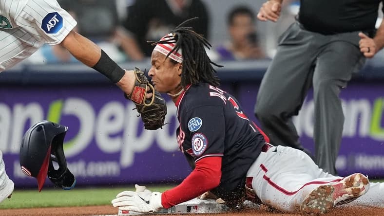 Aug 25, 2023; Miami, Florida, USA; Washington Nationals shortstop CJ Abrams (5) steals third base ahead of the tag by Miami Marlins third baseman Jake Burger (36) in the first inning at loanDepot Park. Mandatory Credit: Jim Rassol-USA TODAY Sports