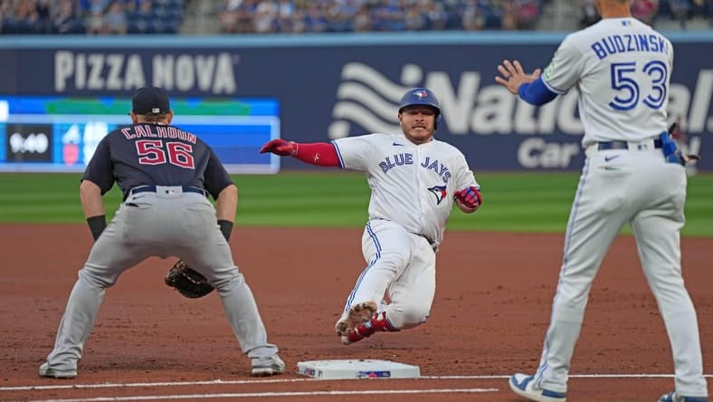 Aug 25, 2023; Toronto, Ontario, CAN; Toronto Blue Jays catcher Alejandro Kirk (30) slides back into first bases after hitting a single against the Cleveland Guardians during the second inning at Rogers Centre. Mandatory Credit: Nick Turchiaro-USA TODAY Sports