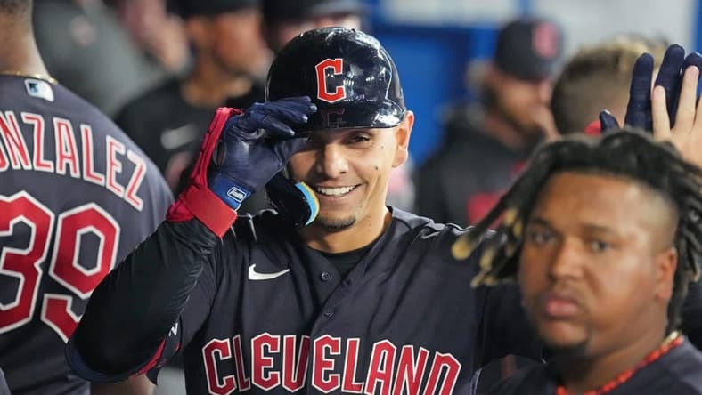 Aug 25, 2023; Toronto, Ontario, CAN; Cleveland Guardians second baseman Andres Gimenez (0) celebrates in the dugout after hitting a home run against the Toronto Blue Jays during the eighth inning at Rogers Centre. Mandatory Credit: Nick Turchiaro-USA TODAY Sports