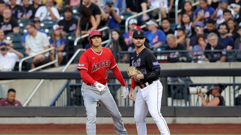 Aug 25, 2023; New York City, New York, USA; Los Angeles Angels designated hitter Shohei Ohtani (17) takes a lead off first base against New York Mets first baseman Pete Alonso (20) after walking during the first inning at Citi Field. Mandatory Credit: Brad Penner-USA TODAY Sports