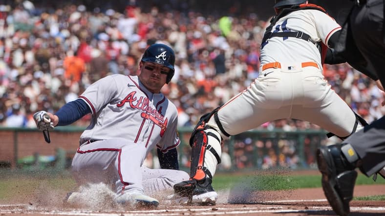 Aug 26, 2023; San Francisco, California, USA; Atlanta Braves infielder Austin Riley (27) slides safely into home against San Francisco Giants catcher Patrick Bailey (14) during the first inning at Oracle Park. Mandatory Credit: Robert Edwards-USA TODAY Sports