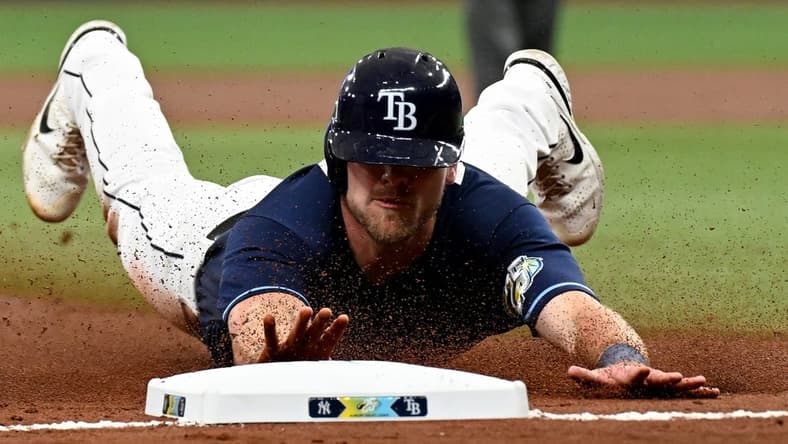 Aug 26, 2023; St. Petersburg, Florida, USA; Tampa Bay Rays center fielder Luke Raley (55) slides into third base against the New York Yankees in the second inning at Tropicana Field. Mandatory Credit: Jonathan Dyer-USA TODAY Sports