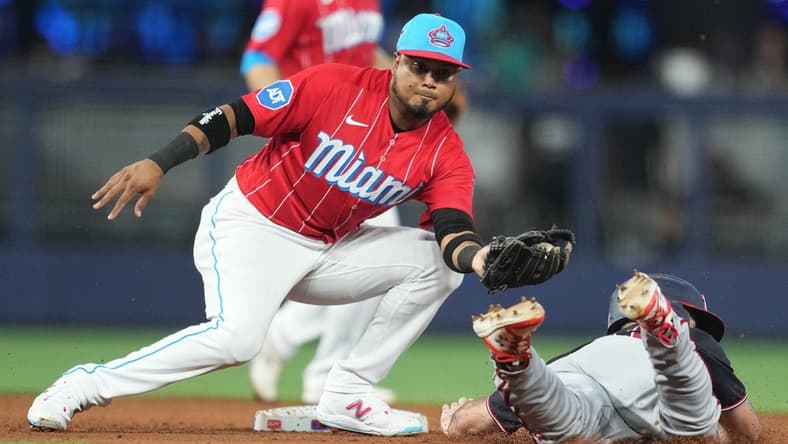 Aug 26, 2023; Miami, Florida, USA; Miami Marlins second baseman Luis Arraez (3) tags out Washington Nationals third baseman Jake Alu (39) trying to steal second base in the fifth inning at loanDepot Park. Mandatory Credit: Jim Rassol-USA TODAY Sports