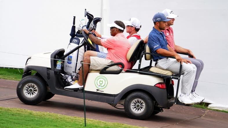 Aug 26, 2023; Atlanta, Georgia, USA; Xander Schauffele and Sam Burns are carted off the course after the horn was blown for a weather delay during the third round of the TOUR Championship golf tournament at East Lake Golf Club. Mandatory Credit: John David Mercer-USA TODAY Sports