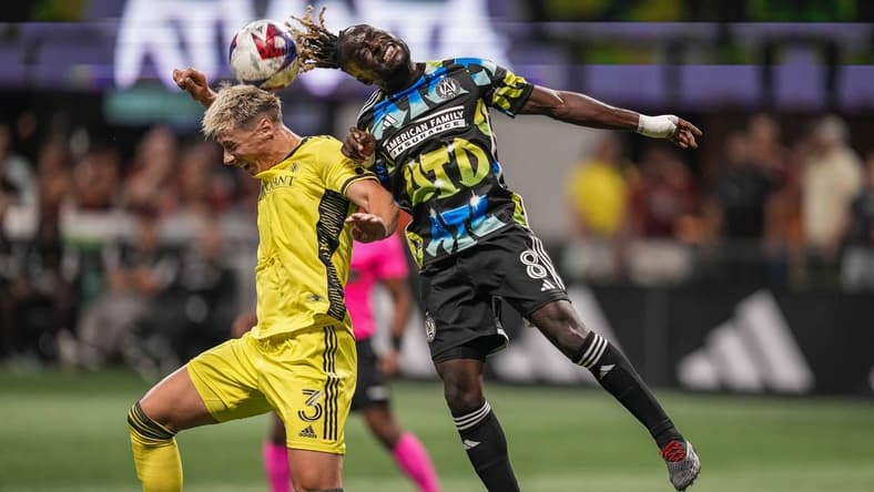 Aug 26, 2023; Atlanta, Georgia, USA; Nashville SC defender Lukas MacNaughton (3) and Atlanta United midfielder Tristan Muyumba (8) battle for the ball during the first half at Mercedes-Benz Stadium. Mandatory Credit: Dale Zanine-USA TODAY Sports