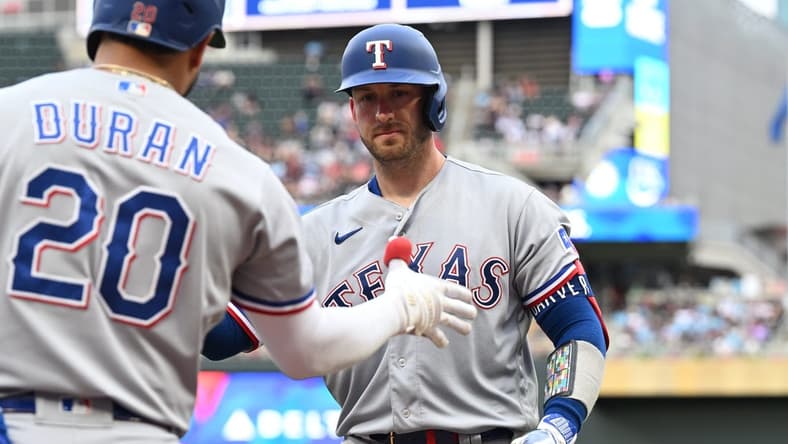Aug 26, 2023; Minneapolis, Minnesota, USA; Texas Rangers catcher Mitch Garver (18) reacts with shortstop Ezequiel Duran (20) after hitting a home run off Minnesota Twins starting pitcher Joe Ryan (not pictured) during the second inning at Target Field. Mandatory Credit: Jeffrey Becker-USA TODAY Sports