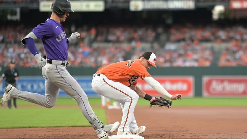 Aug 26, 2023; Baltimore, Maryland, USA;  Baltimore Orioles first baseman Ryan Mountcastle (6) secures the ball for the forecourt of Colorado Rockies right fielder Nolan Jones (22) during the second inning at Oriole Park at Camden Yards. Mandatory Credit: Tommy Gilligan-USA TODAY Sports