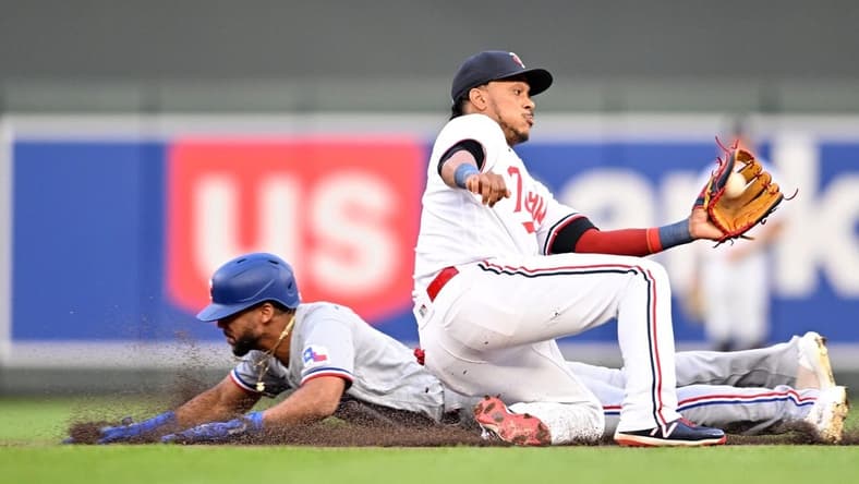 Aug 26, 2023; Minneapolis, Minnesota, USA; Texas Rangers center fielder Leody Taveras (3) slides in safe while stealing second base as Minnesota Twins second baseman Jorge Polanco (11) catches the ball to apply the tag during the fifth inning at Target Field. Mandatory Credit: Jeffrey Becker-USA TODAY Sports