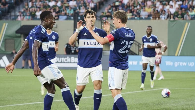 Aug 26, 2023; Portland, Oregon, USA; Vancouver Whitecaps midfielder Ryan Gauld (25) celebrates with teammates after scoring a goal in the first half against the Portland Timbers at Providence Park. Mandatory Credit: Troy Wayrynen-USA TODAY Sports