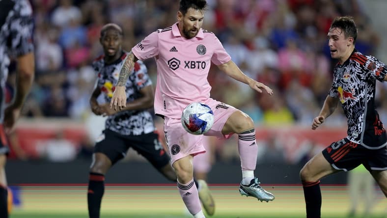 Aug 26, 2023; Harrison, New Jersey, USA; Inter Miami CF forward Lionel Messi (10) controls the ball against New York Red Bulls defender Andres Reyes (4) and midfielder Peter Stroud (5) during the second half at Red Bull Arena. Mandatory Credit: Brad Penner-USA TODAY Sports
