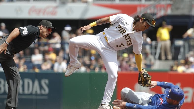 Aug 27, 2023; Pittsburgh, Pennsylvania, USA;  Chicago Cubs designated hitter Cody Bellinger (right) steals second base as Pittsburgh Pirates second baseman Ji Hwan Bae (3) applies a late tag during the first inning at PNC Park. Mandatory Credit: Charles LeClaire-USA TODAY Sports