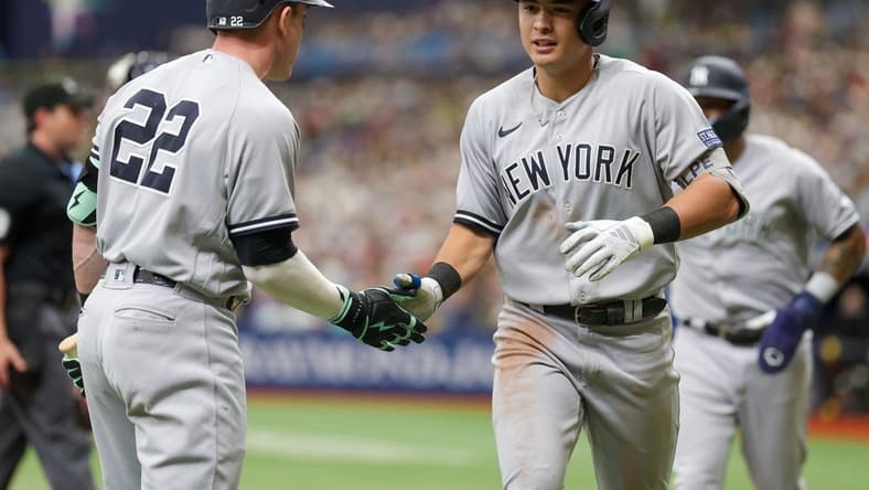 Aug 27, 2023; St. Petersburg, Florida, USA; New York Yankees center fielder Harrison Bader (22) congratulates shortstop Anthony Volpe (11) after hitting a two run home run against the Tampa Bay Rays in the fourth inning at Tropicana Field. Mandatory Credit: Nathan Ray Seebeck-USA TODAY Sports