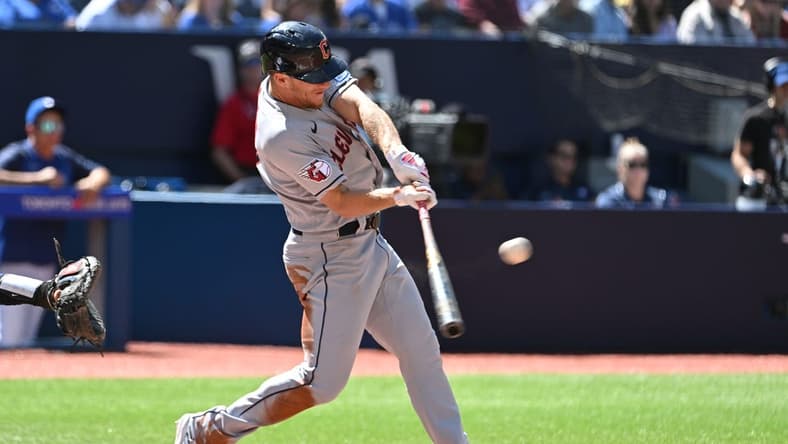 Aug 27, 2023; Toronto, Ontario, CAN;  Cleveland Guardians center fielder Myles Straw (7) hits an RBI single against the Toronto Blue Jays in the fourth inning at Rogers Centre. Mandatory Credit: Dan Hamilton-USA TODAY Sports