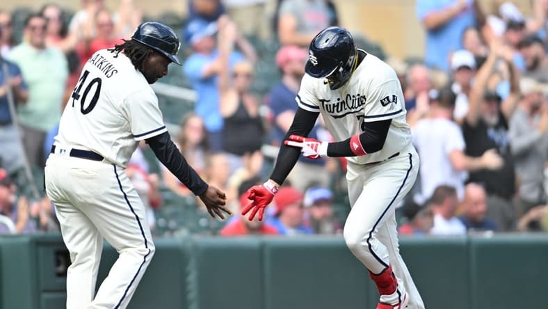 Aug 27, 2023; Minneapolis, Minnesota, USA; Minnesota Twins third baseman Royce Lewis (23) reacts with third base coach/outfield coach Tommy Watkins (40) after hitting a grand slam off Texas Rangers relief pitcher Chris Stratton (not pictured) during the sixth inning at Target Field. Mandatory Credit: Jeffrey Becker-USA TODAY Sports