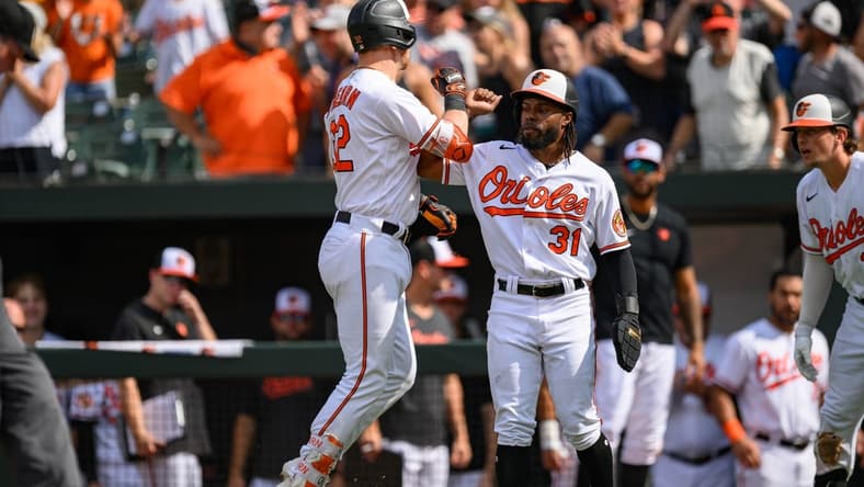 Aug 27, 2023; Baltimore, Maryland, USA; Baltimore Orioles first baseman Ryan O'Hearn (32) celebrates with center fielder Cedric Mullins (31) after hitting a two run home run during the eighth inning against the Colorado Rockies at Oriole Park at Camden Yards. Mandatory Credit: Reggie Hildred-USA TODAY Sports