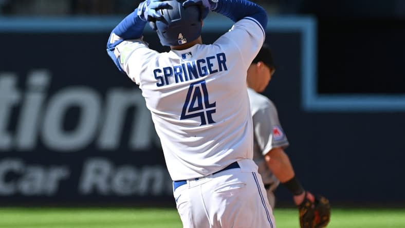 Aug 27, 2023; Toronto, Ontario, CAN; Toronto Blue Jays right fielder George Springer (4) reacts after his fly ball to the center field wall is caught by Cleveland Guardians center fielder Myles Straw (not pictured) in the eighth  inning at Rogers Centre. Mandatory Credit: Dan Hamilton-USA TODAY Sports