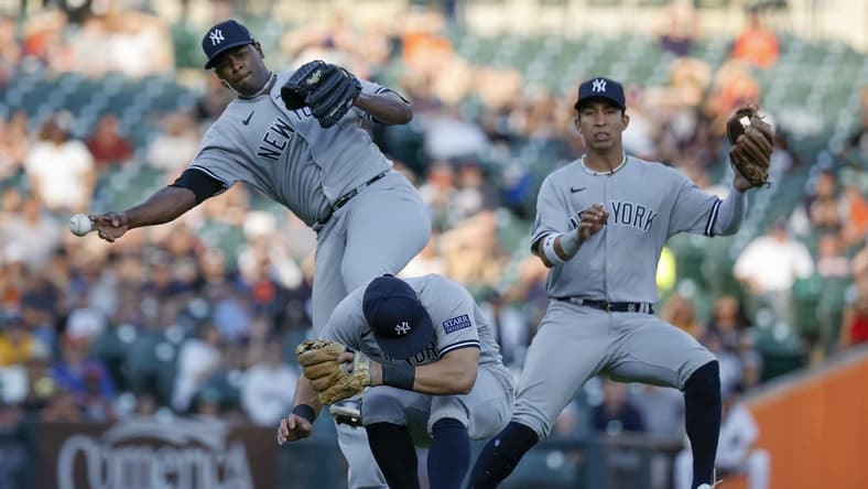 Aug 28, 2023; Detroit, Michigan, USA; New York Yankees starting pitcher Luis Severino (40) makes a throw to first as he avoids shortstop Anthony Volpe (11) and third baseman Gleyber Torres (25) in the second inning at Comerica Park. Mandatory Credit: Rick Osentoski-USA TODAY Sports