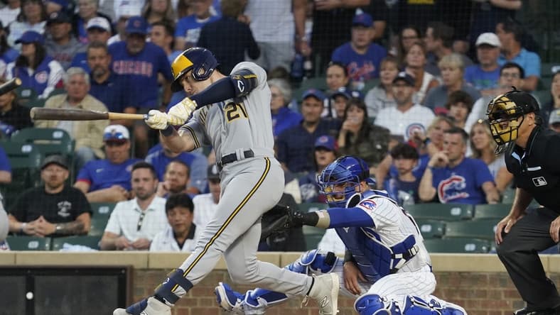 Aug 28, 2023; Chicago, Illinois, USA; Milwaukee Brewers designated hitter Mark Canha (21) hits a two-run home run against the Chicago Cubs during the first inning at Wrigley Field. Mandatory Credit: David Banks-USA TODAY Sports