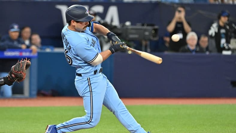 Aug 28, 2023; Toronto, Ontario, CAN;  Toronto Blue Jays third baseman Davis Schneider (36) hits an RBI single against the Washington National in the second inning at Rogers Centre. Mandatory Credit: Dan Hamilton-USA TODAY Sports