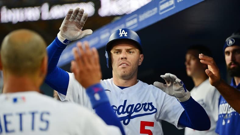 Aug 28, 2023; Los Angeles, California, USA; Los Angeles Dodgers first baseman Freddie Freeman (5) is greeted after hitting a solo home run against the Arizona Diamondbacks during the first inning at Dodger Stadium. Mandatory Credit: Gary A. Vasquez-USA TODAY Sports