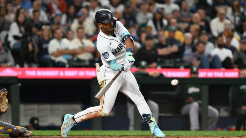 Aug 28, 2023; Seattle, Washington, USA; Seattle Mariners center fielder Julio Rodriguez (44) hits a 2-run home run against the Oakland Athletics during the third inning at T-Mobile Park. Mandatory Credit: Steven Bisig-USA TODAY Sports