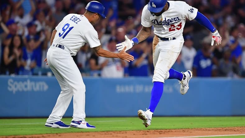 Aug 28, 2023; Los Angeles, California, USA; Los Angeles Dodgers right fielder Jason Heyward (23) is greeted by third base coach Dino Ebel (91) after hitting a two run home run against the Arizona Diamondbacks during the sixth inning at Dodger Stadium. Mandatory Credit: Gary A. Vasquez-USA TODAY Sports